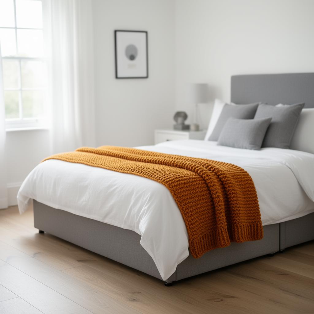 Bright UK bedroom with warm ochre throw